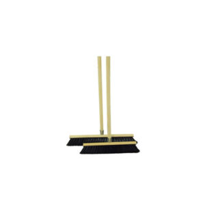 Gold-colored broom set with two tall handles standing upright and two black-bristled broom heads on the floor beneath.