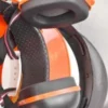Close-up of orange and black over-ear headphones with cushioned ear cups and headband.