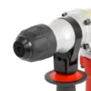 Close-up of a power drill's metal chuck and grip, shown from the front with a red adjustment ring.