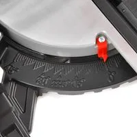 Close-up of a power tool blade guard with a red locking pin attached.