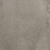 Close-up of a gray concrete surface with small pebbles and uneven texture.