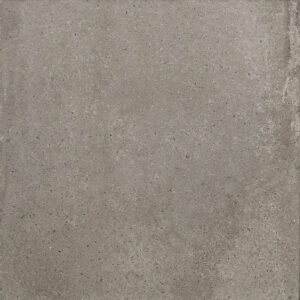 Close-up of a gray concrete surface with small pebbles and uneven texture.
