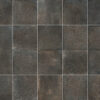 Close-up of dark gray metal tiles with white grout lines in a grid pattern.