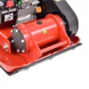 Close-up of a red engine housing with a yellow hazard triangle and bolts.