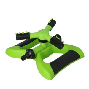 Green lawn sprinkler with four black spray arms arranged in a star pattern, designed to water a lawn evenly