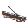 Manual tile cutter with orange base and black handle, used to score and snap ceramic tiles on a workshop bench.